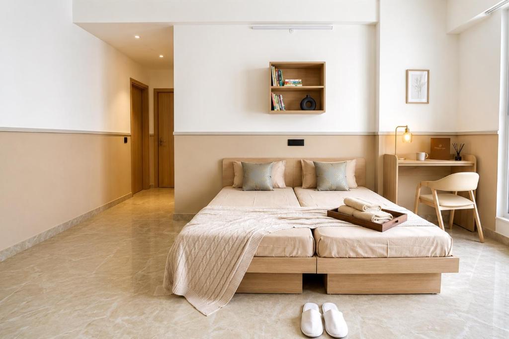 a bedroom with a large bed and a desk at AS Living Guest House - A boutique stay near Apollo Hospital, City Center Mall, PhysicsWallah, Allen, SPM in Guwahati