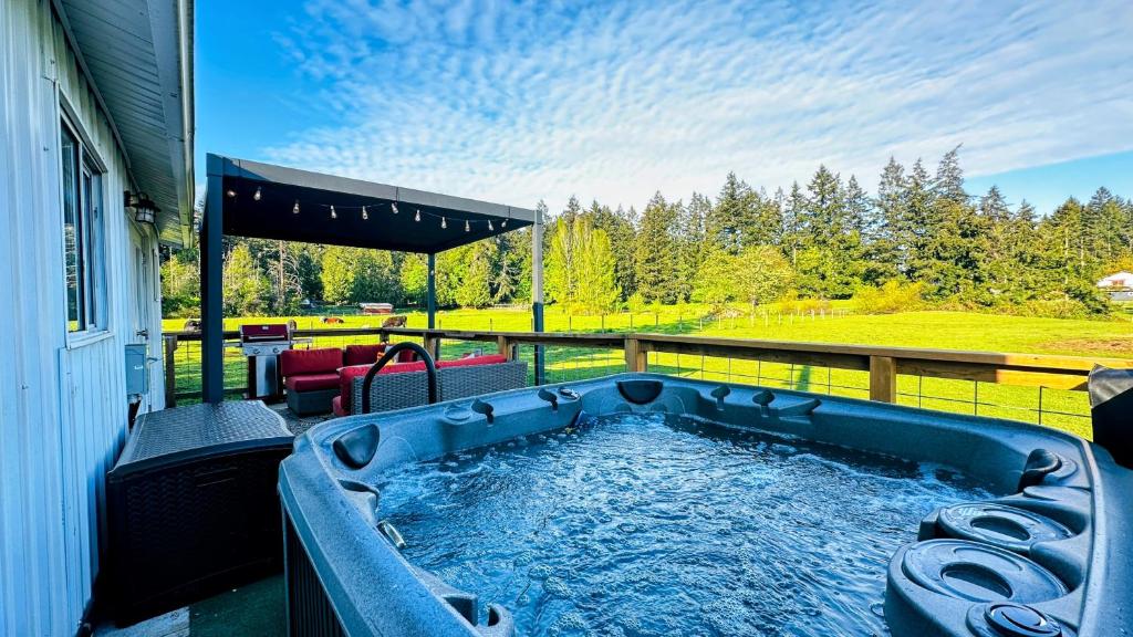 a hot tub on the back of a house at The Cottage on the Farm in Ladysmith