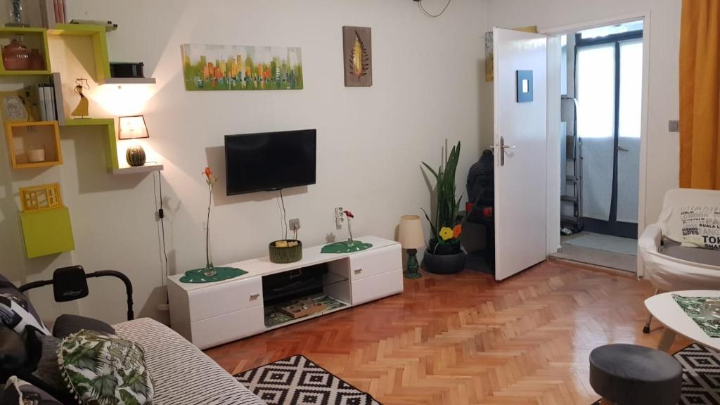 a living room with a tv on a wall at Katata Apartment One -Bedrom in Podgorica