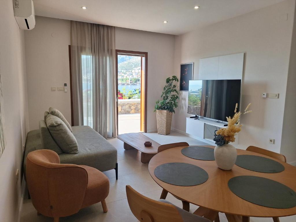 a living room with a table and a couch at 4 stars - apartments Senj in Senj