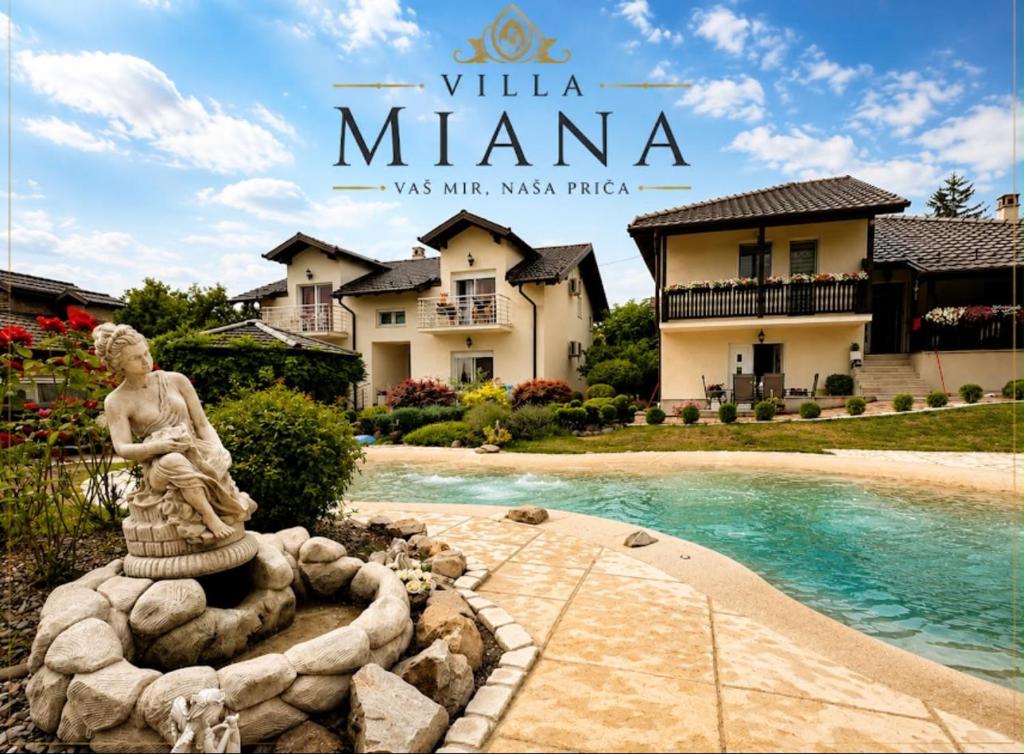 a fountain in front of a villa mimka with a house at Vila Miana apartmani in Vrdnik