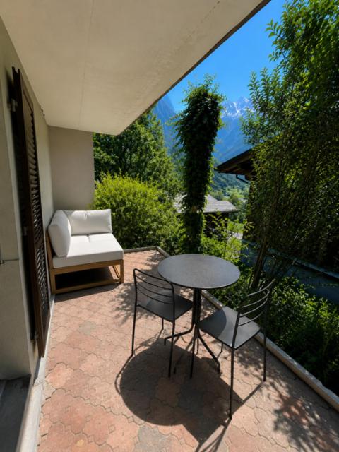 a patio with a table and chairs and a couch at Eiger View in Grindelwald