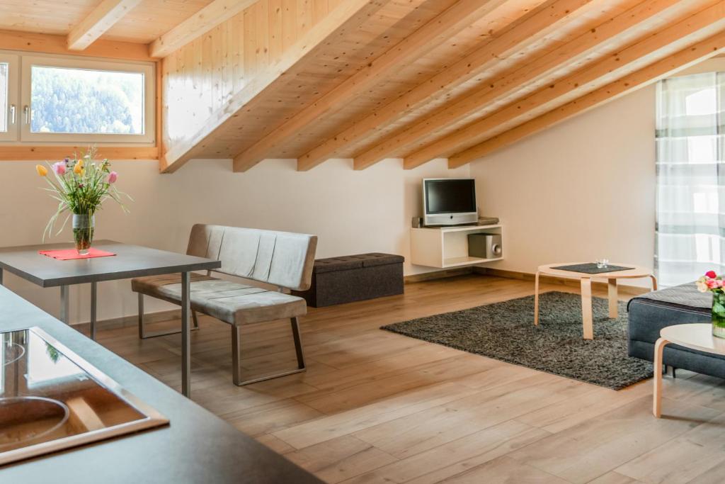 a living room with a table and a couch at Falgerhof in Vollan