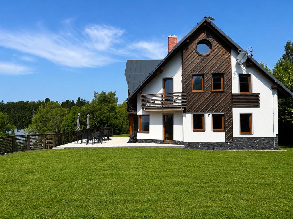 a large white house with a gambrel roof at Psí bouda Benecko in Benecko