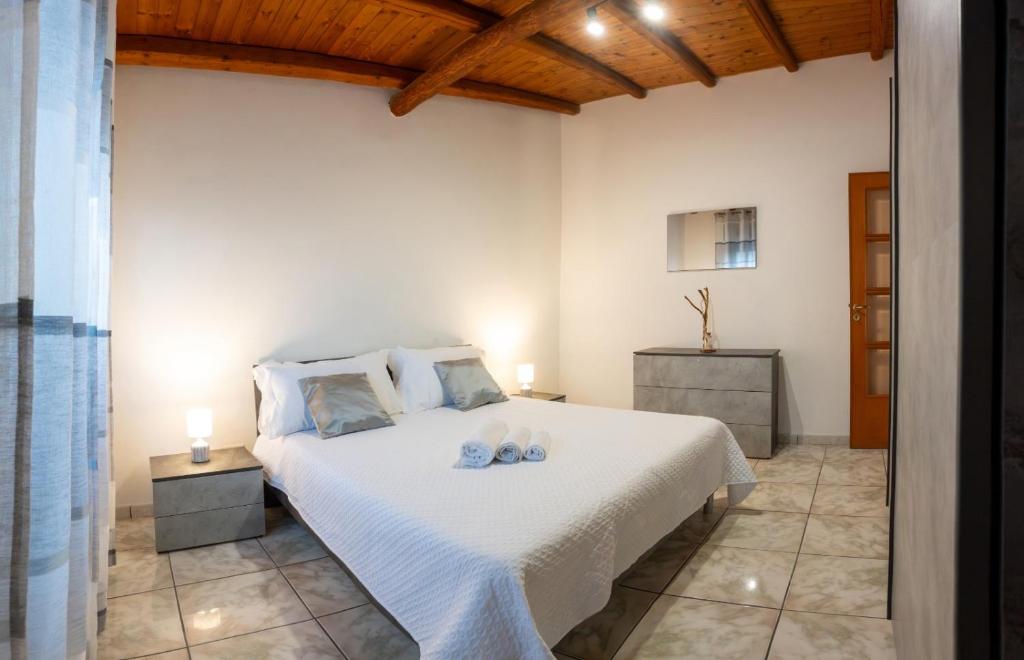 a bedroom with a bed with two shoes on it at Amò Casa in Fiumefreddo di Sicilia
