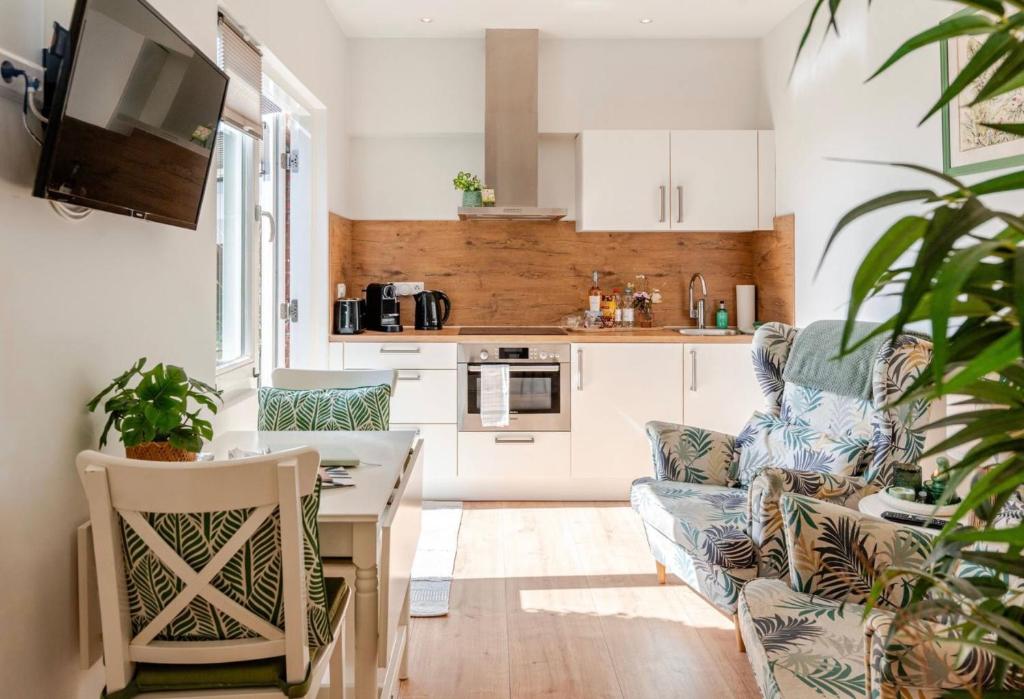 a kitchen with a couch and a table in a room at Lou-Lou in Zandvoort