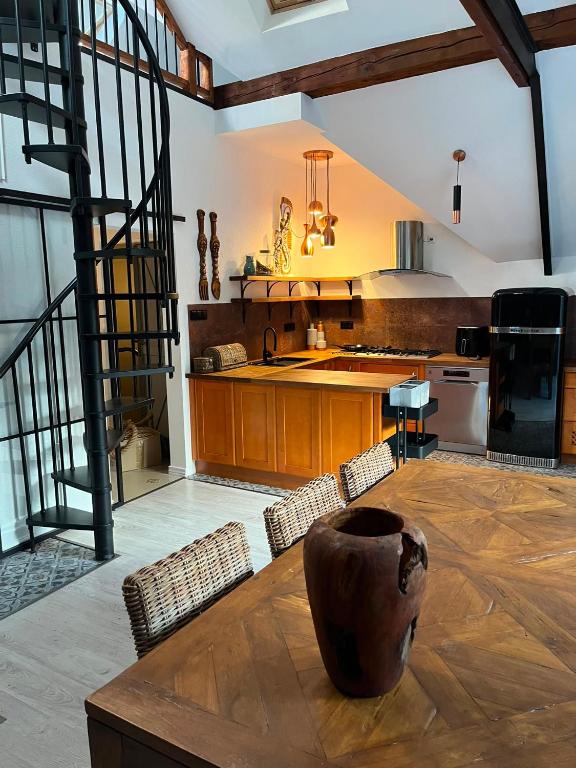 a large kitchen with a wooden table and chairs at Apartament Morgan in Mieroszyno