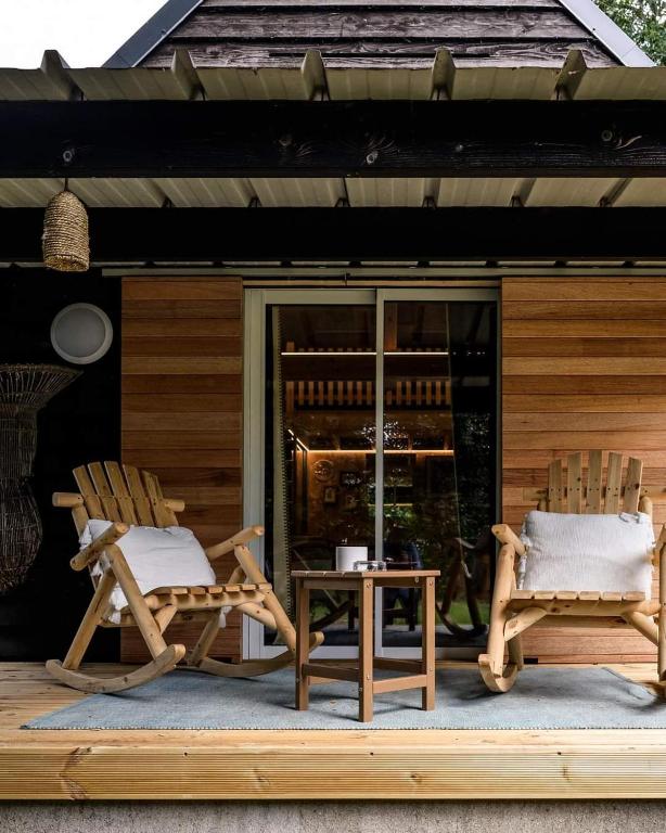 two chairs and a table on a patio at La Mare aux Oiseaux, The Originals Collection in Saint-Joachim