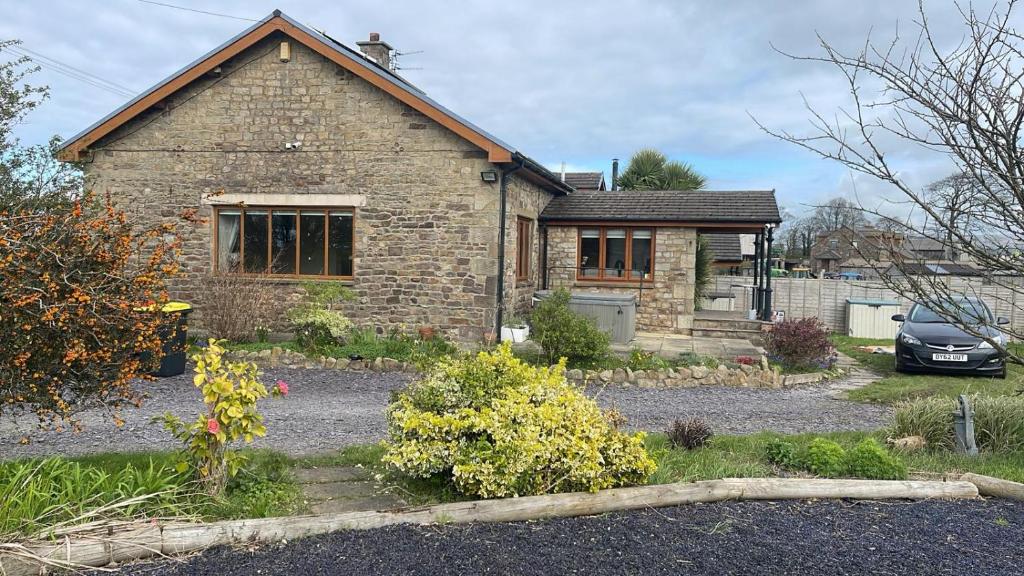 a brick house with a car parked in front of it at Batty lodge in Cockerham
