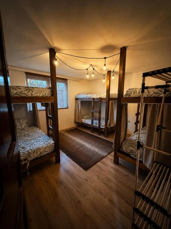 a room with three bunk beds in a house at Pure Sleep in Prizren
