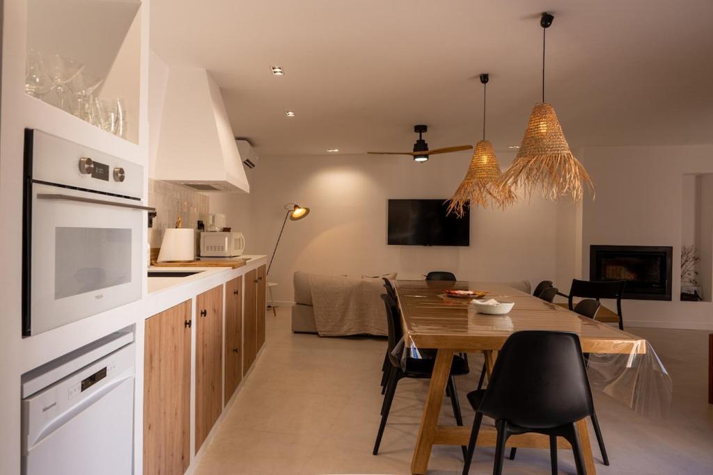 a kitchen and dining room with a table and chairs at Casa Aurora in Almoharín