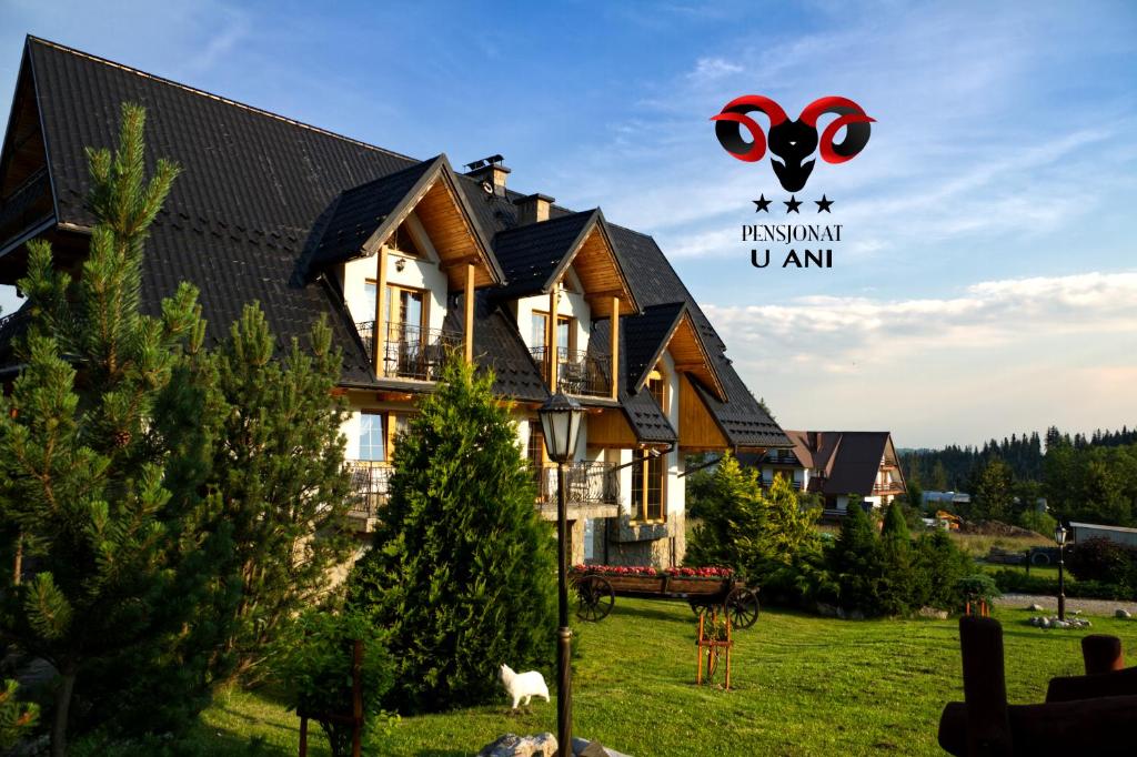 a house with a sign that reads insulin island u am at Pensjonat u Ani in Zakopane