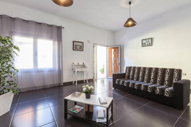 a living room with a couch and a table at Casa das Gazânias in Cabeceiras de Basto