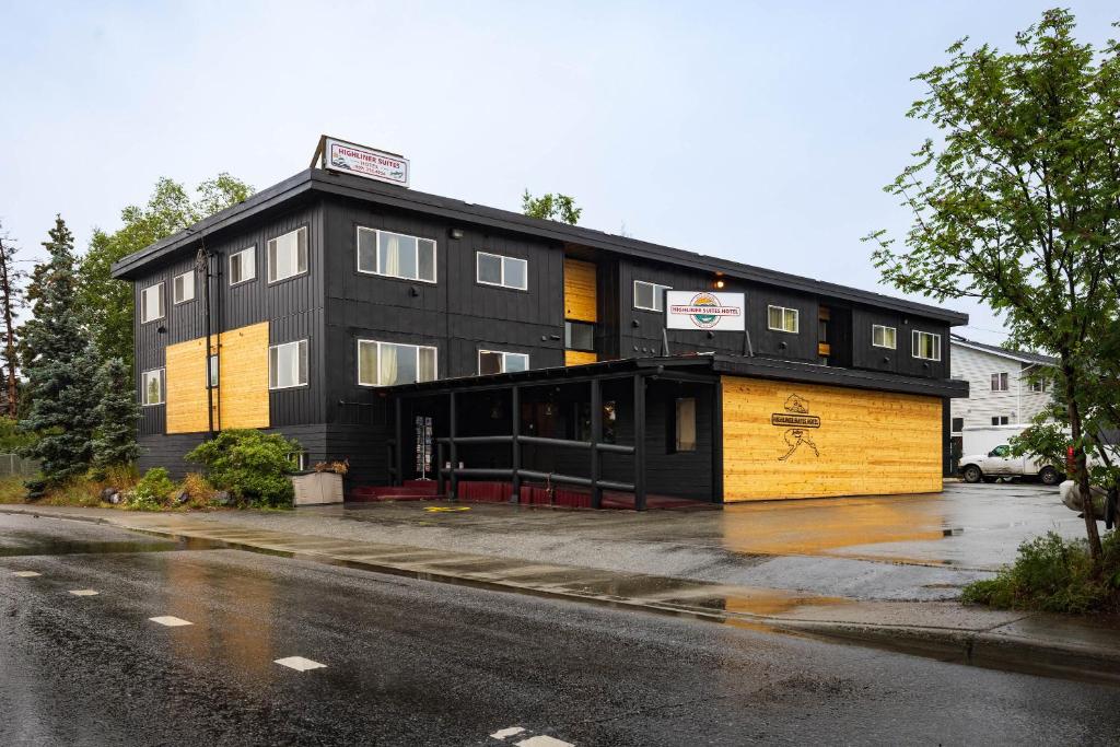 a black and yellow building on the side of a street at Highliner Suites Hotel in Anchorage