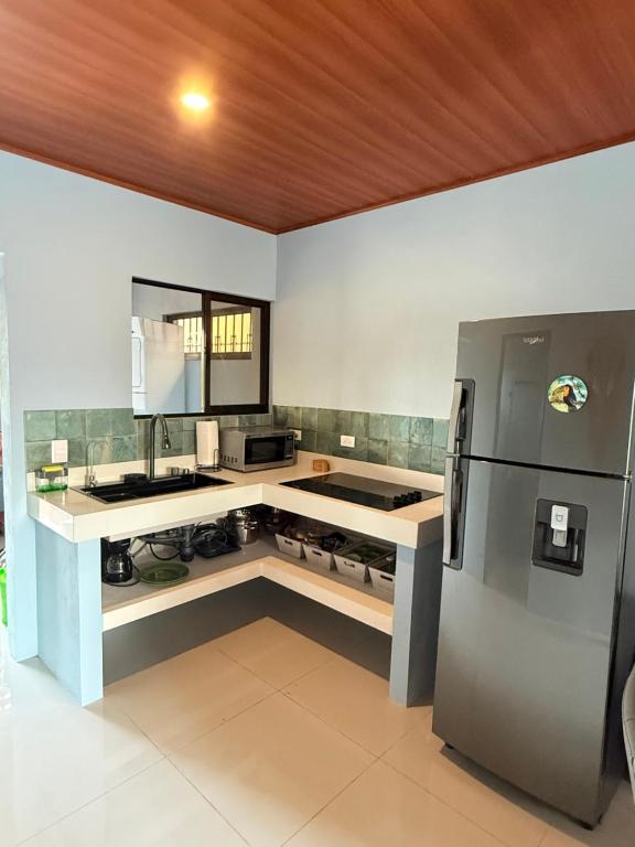 a kitchen with a sink and a refrigerator at El Refugio de Montenegro in Montenegro