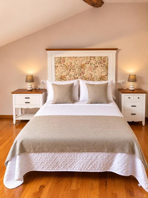 a bedroom with a large bed with two night stands at Casa Portos in Lestedo