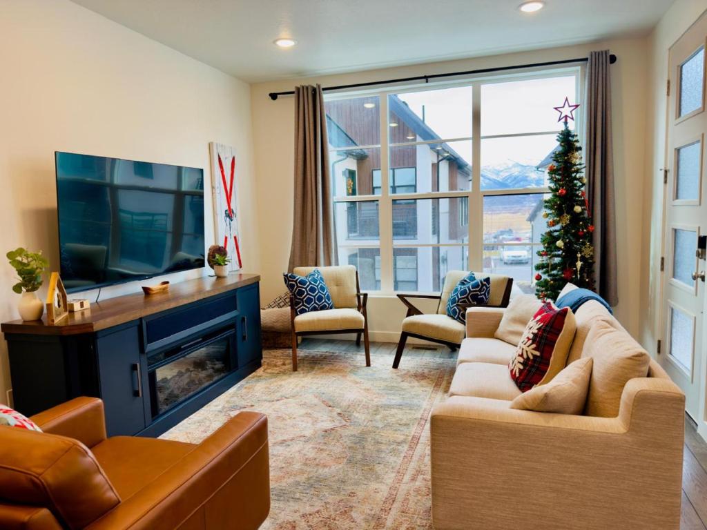 a living room with a fireplace and a christmas tree at Retro Ski Chalet in Heber City