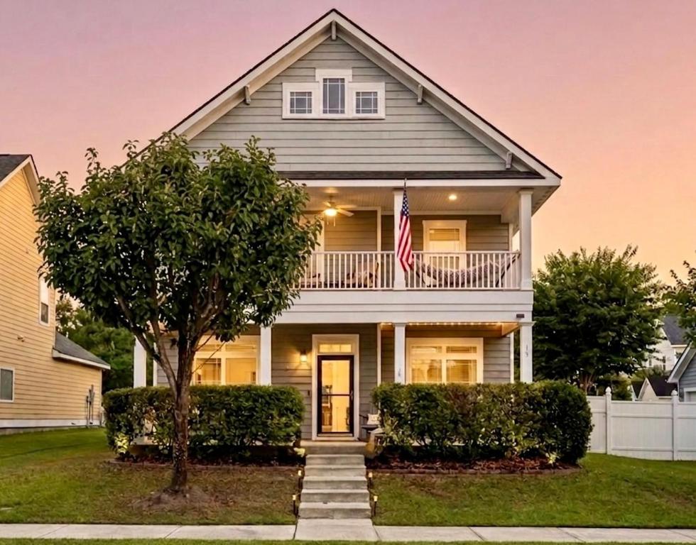 a house with an american flag in front of it at Fenced Yard, Pool, Lazy River SAV Area Oasis! in Savannah