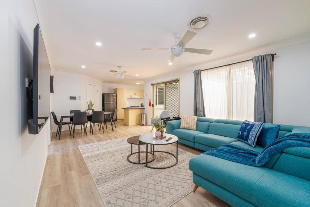 a living room with a blue couch and a table at 3BR Guesthouse w Sunroom Near Stanhope Leisure in Glenwood