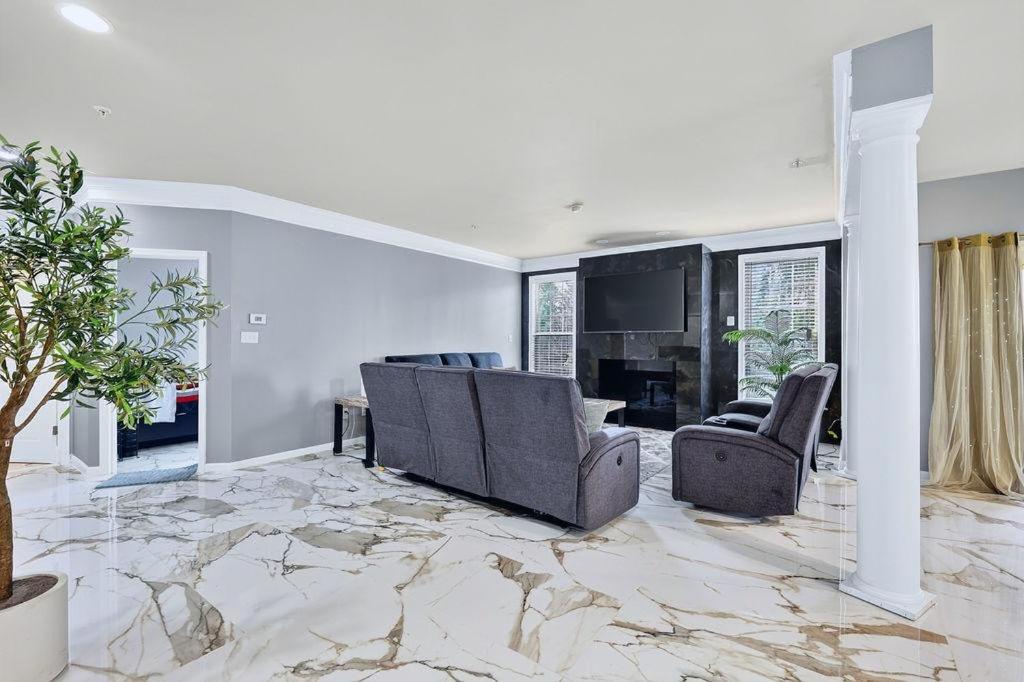 a living room with a couch and chairs and a tv at Sunshine Cozy Crib in Glenarden