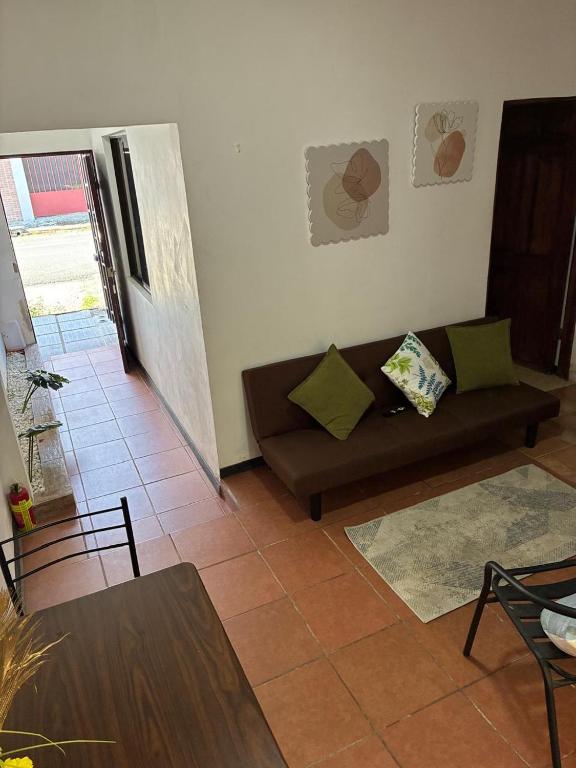 a living room with a couch and a table at Buganvilla Quepos No 2 Aire acondicionado in Quepos