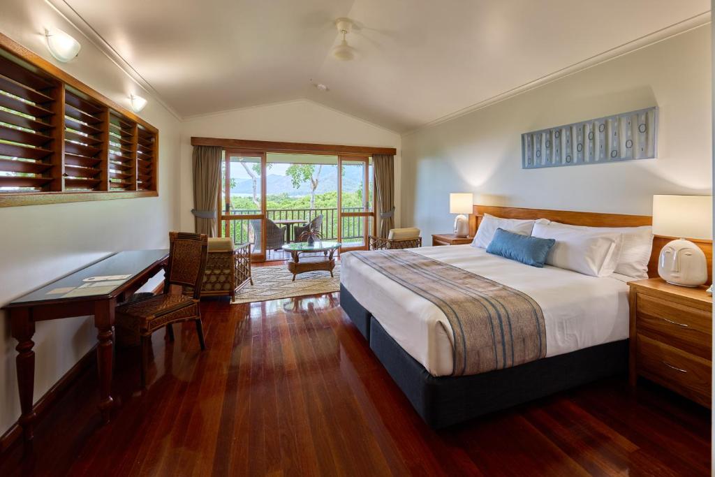 a hotel room with a bed and a desk and a desk at Thala Beach Nature Reserve in Port Douglas