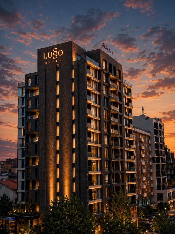 a building with a usos sign on top of it at Lusso Hotel in Prishtinë