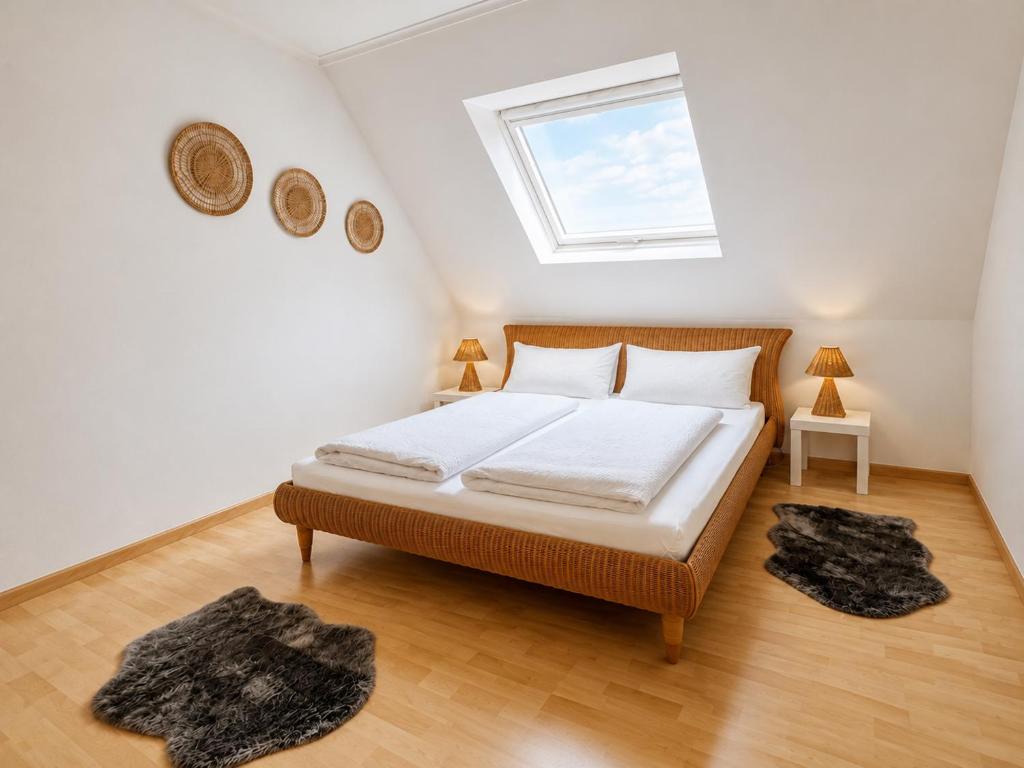 a bedroom with a bed with white sheets and a window at Fewo ONE - by Europapark in Rust