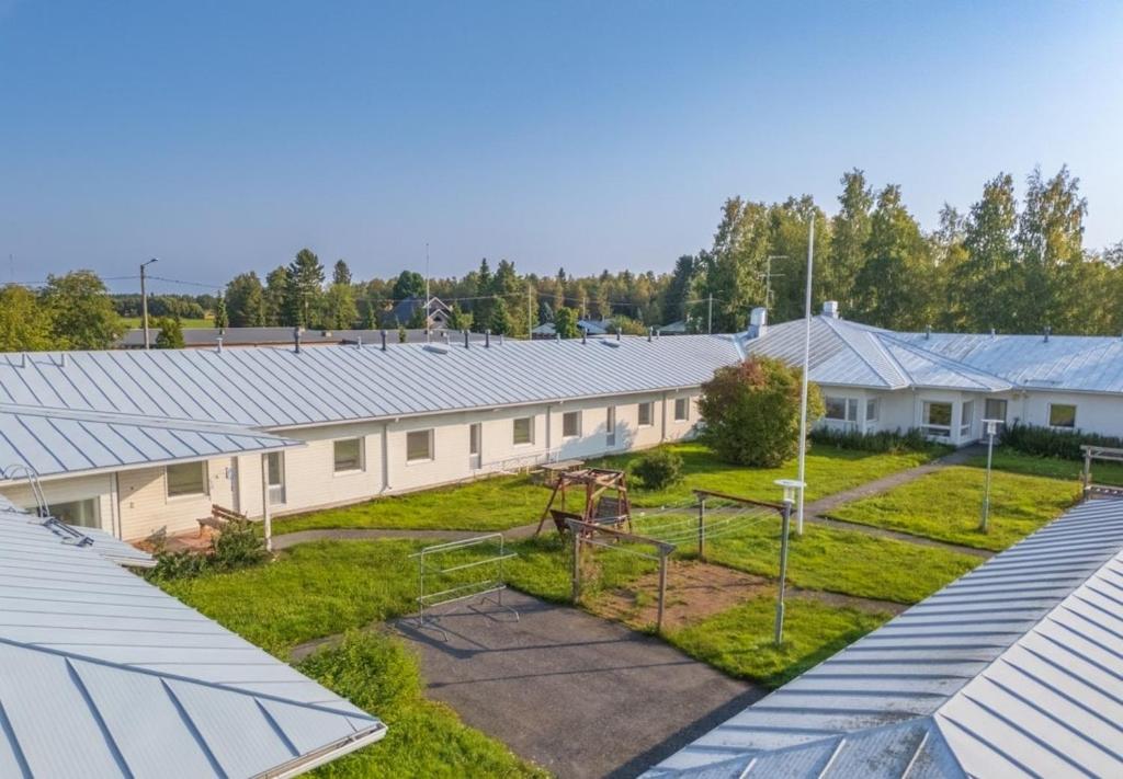 a row of buildings with solar panels on the roofs at Private apartment in Kokkola