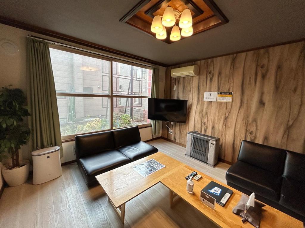 a living room with a couch and a table at 永山邸 in Asahikawa