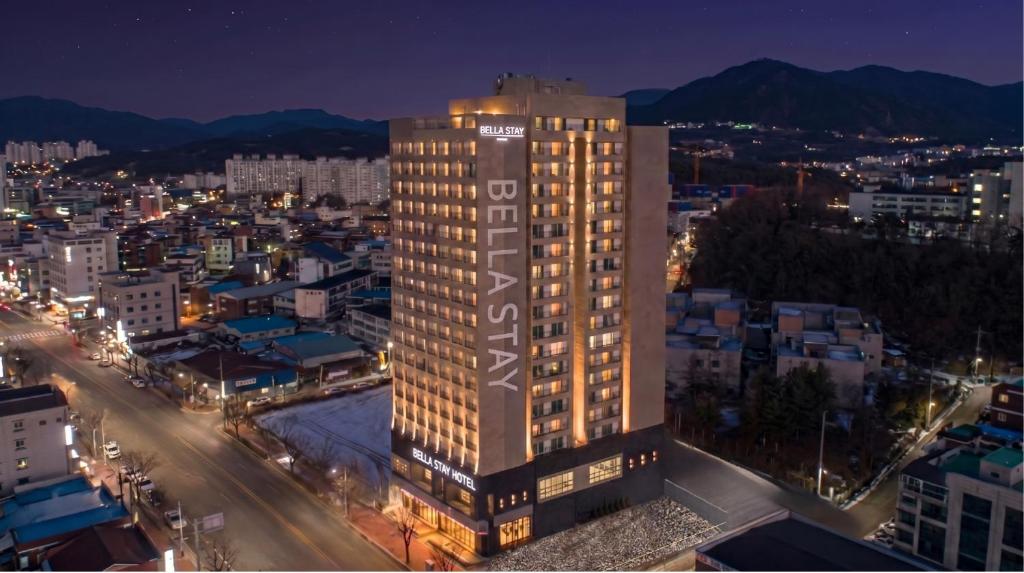a tall building in a city at night at Bella Stay in Chuncheon