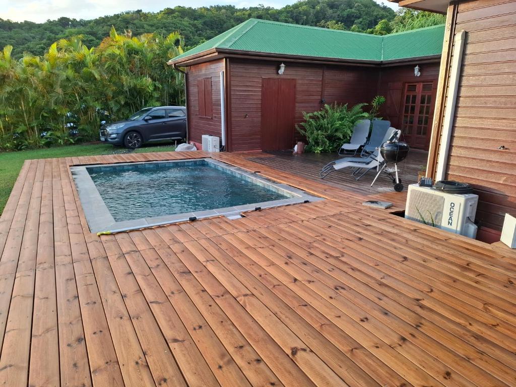 a deck with a swimming pool on a house at Chalet vue mer, piscine in Saint-Claude