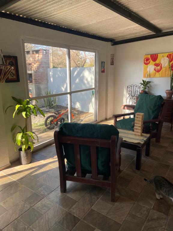 a living room with a couch and a window at Tres Raíces in Miramar