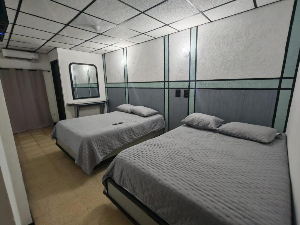 a room with two beds and a tv in it at El santa lucia in Panama City