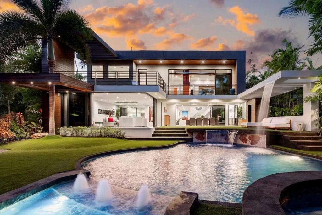 a house with a swimming pool in front of a house at Villa Kahala Honolu With Pool in Honolulu