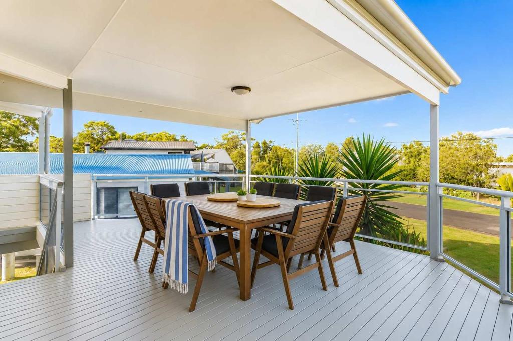a patio with a table and chairs on a deck at Dream Weaver in Bawley Point