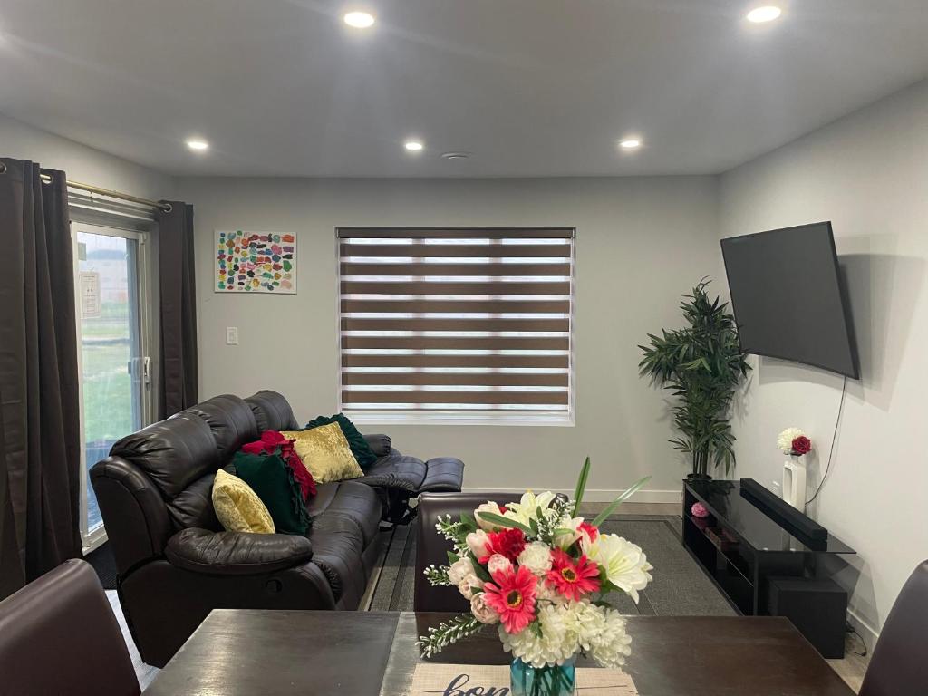 a living room with a couch and a table at Lakeview 2Bedroom Walkout Suite with Trail View in Winnipeg