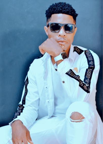 a man wearing sunglasses and a white shirt and tie at RB Global Inc and RB Wizzy Ventures in Somanya