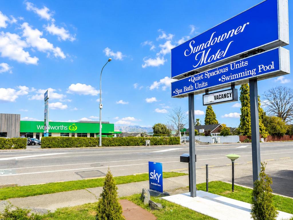 a sign for a store on the side of a road at Sundowner Motel in Blenheim