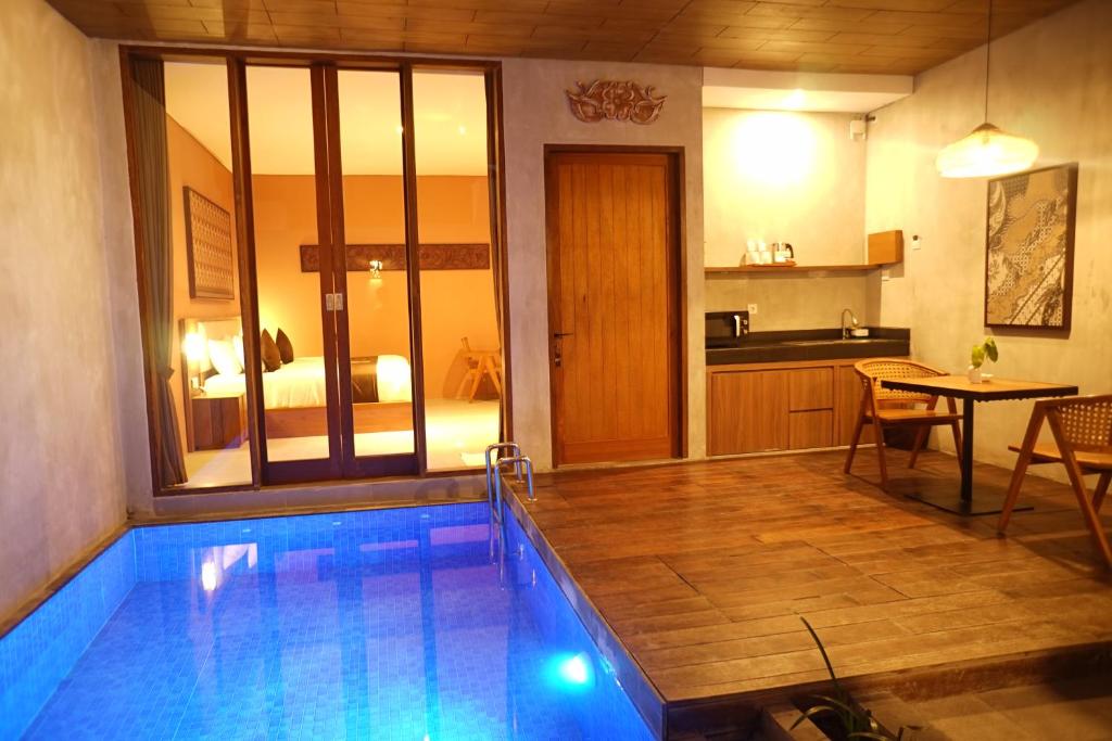 a swimming pool in a room with a bedroom at ME Villas Pererenan, Canggu in Canggu