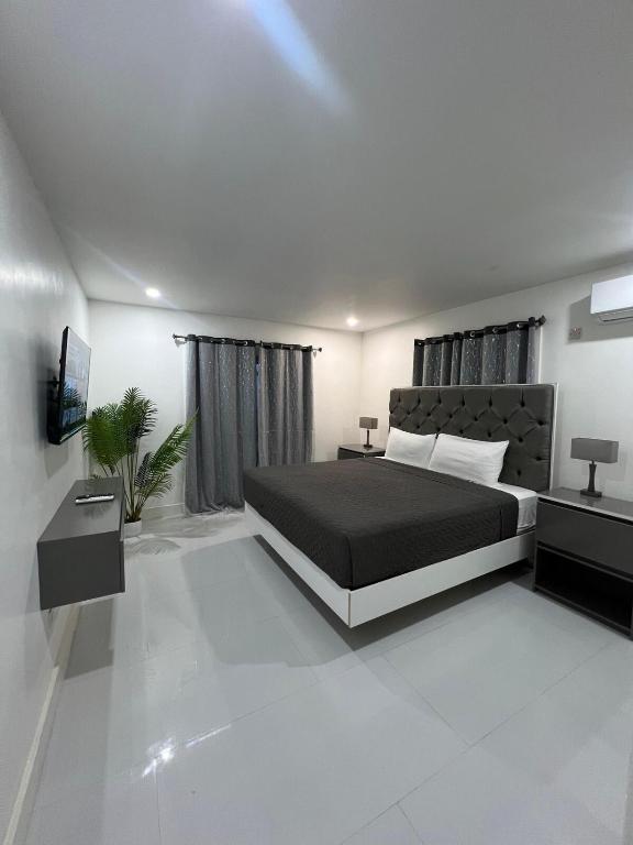 a bedroom with a large bed and a television at Deluxe two 2 bedroom in Priory