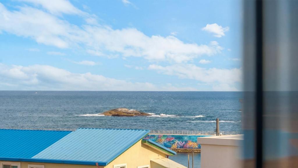 a view of the ocean from a building at Sokcho Jaja Ocean View Pension in Sokcho