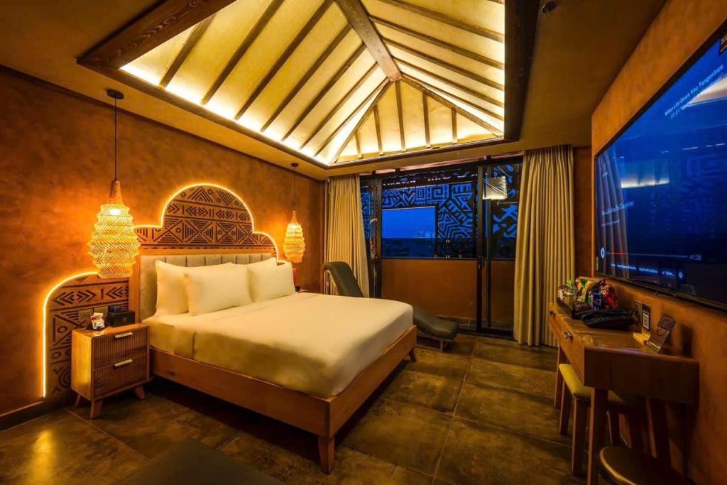 ein Schlafzimmer mit einem großen Bett und einem Fernseher in der Unterkunft Pynt Hotel 8 in Ho-Chi-Minh-Stadt