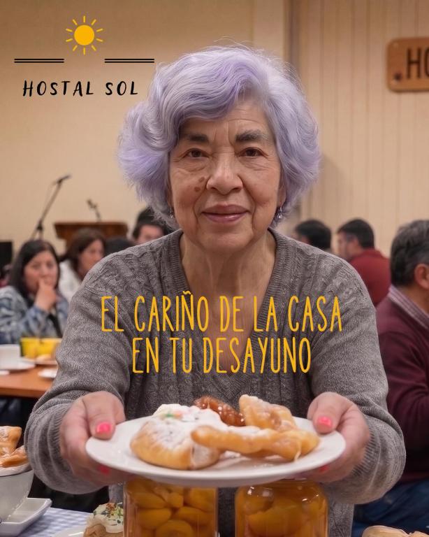 an older woman holding a plate of food at Hostal Sol Temuco in Temuco