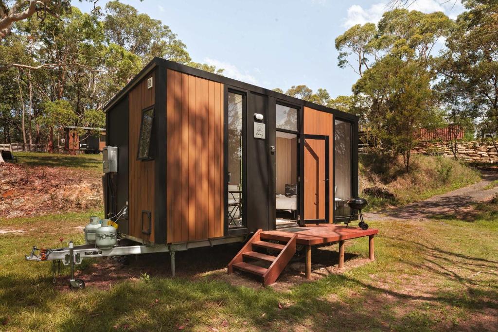 a tiny house on a trailer in a field at Maroota Greens X by Tiny Away in Maroota