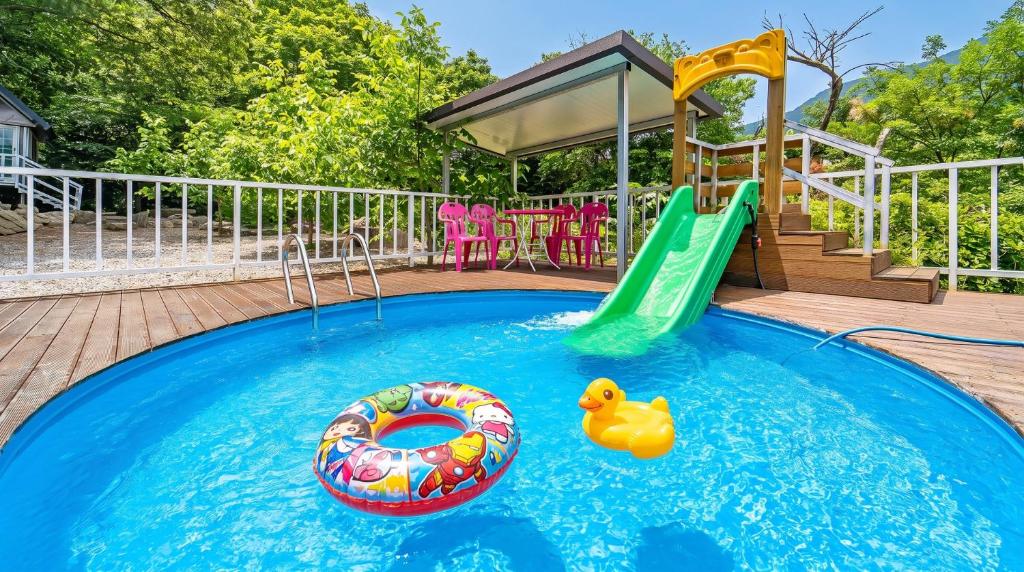a pool with a slide and a rubber duck in it at Gapyeong Pogny Kids Poolvilla in Gapyeong