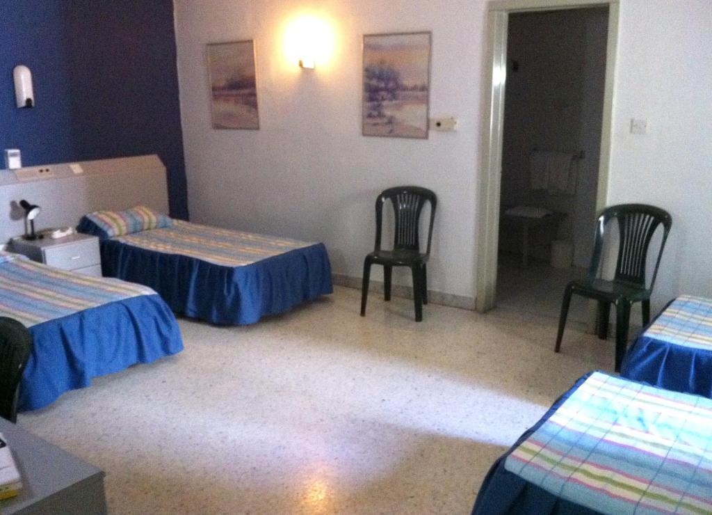 Postel nebo postele na pokoji v ubytování Roma Hotel