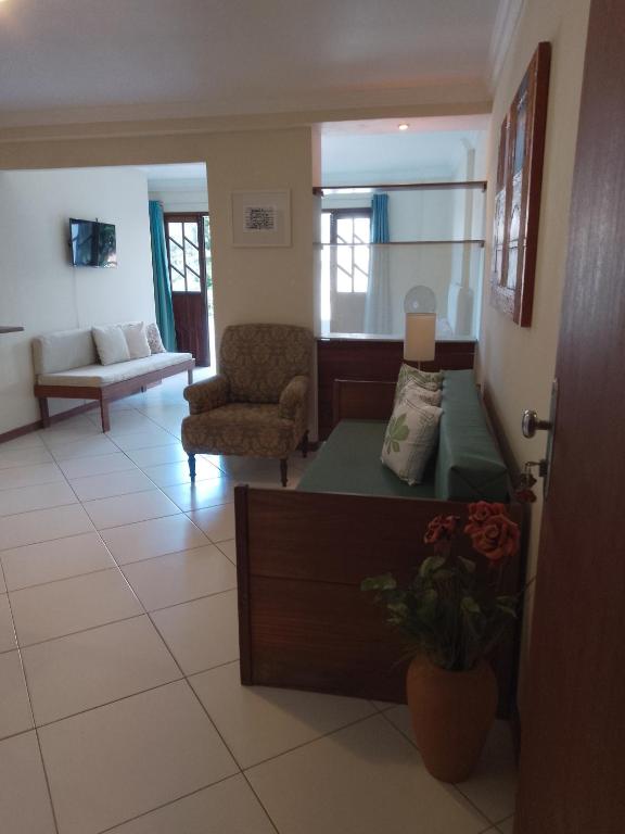 a living room with a bed and a couch at Residencial Ribeiro in Salvador