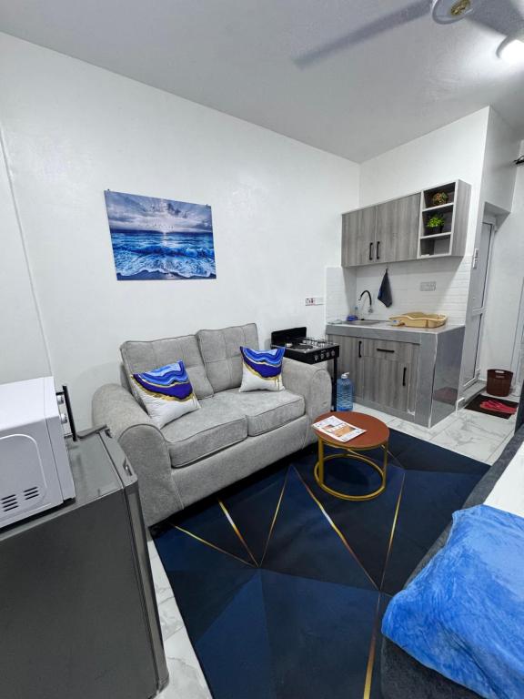a living room with a couch and a kitchen at Peace Nest bamburi in Mombasa