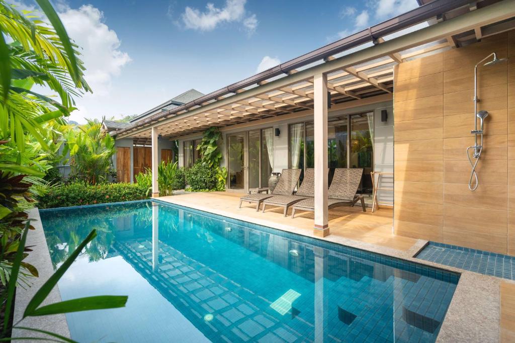 a swimming pool in the backyard of a house at Tropical Private Pool Villa Dalaa 9 in Kamala Beach